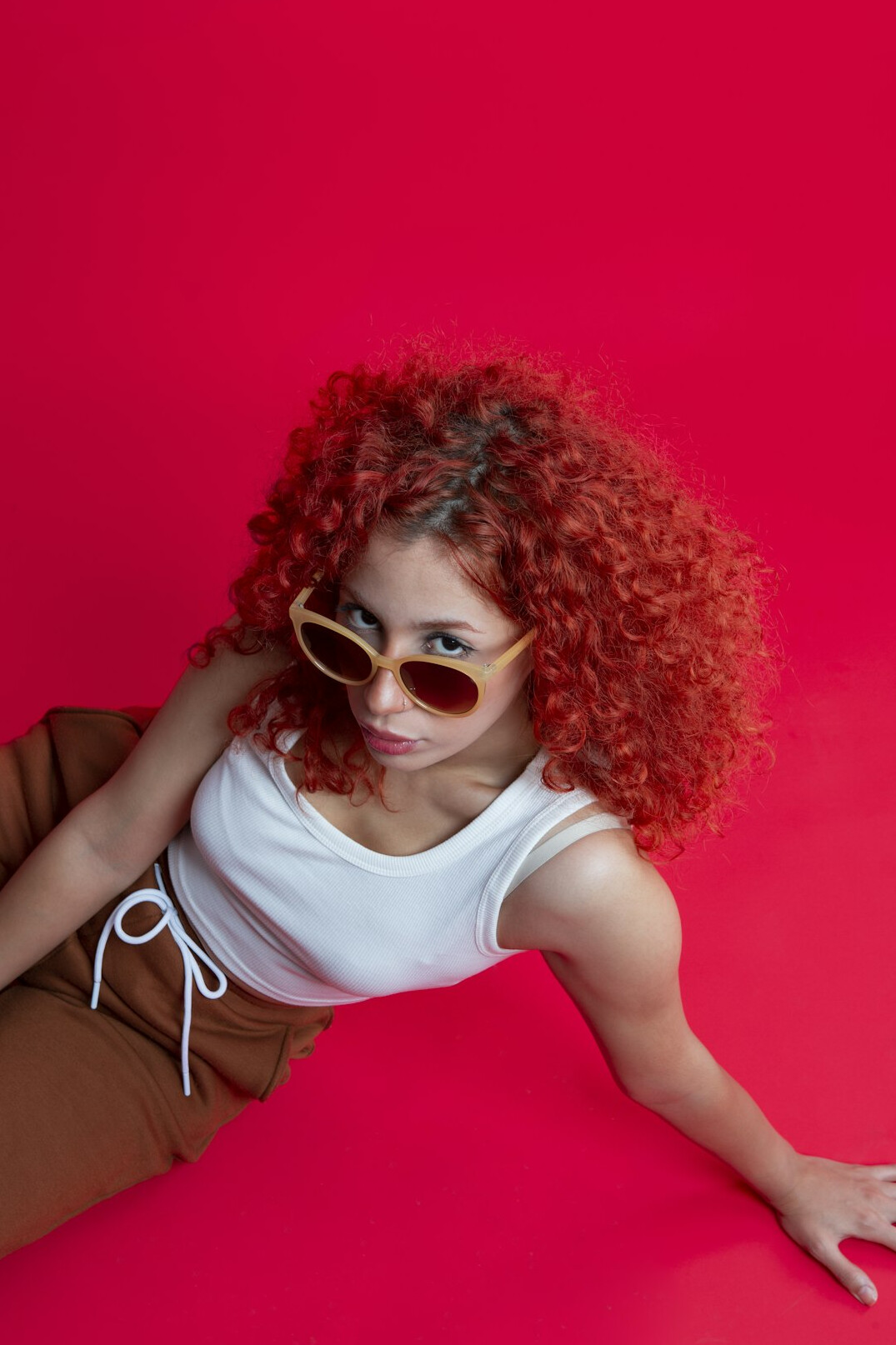 Woman with red hair and glasses in studio portrait
